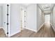 Hallway with hardwood floors, white trim and doors, and modern lighting creates a clean aesthetic at 5308 Citrus Leaf Blvd, Winter Garden, FL 34787