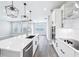 Well-lit open kitchen featuring a large island, stainless steel appliances, and modern pendant lighting at 5308 Citrus Leaf Blvd, Winter Garden, FL 34787