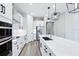 This modern kitchen boasts white cabinetry, stainless steel appliances, and a large island with sink at 5308 Citrus Leaf Blvd, Winter Garden, FL 34787