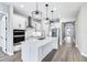 Bright, modern kitchen features white cabinets, stainless steel appliances, and a large center island at 5308 Citrus Leaf Blvd, Winter Garden, FL 34787
