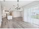 Bright open-concept living area features a modern chandelier and sliding glass doors to the backyard at 5308 Citrus Leaf Blvd, Winter Garden, FL 34787