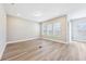 Bright, open-concept living room showcasing wood floors, neutral paint, and natural light at 5308 Citrus Leaf Blvd, Winter Garden, FL 34787