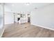 Spacious living room showcasing wood flooring with modern kitchen island and appliances at 5308 Citrus Leaf Blvd, Winter Garden, FL 34787