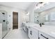 Bright bathroom featuring dual vanity, marble floors, glass shower, and soaking tub at 5308 Citrus Leaf Blvd, Winter Garden, FL 34787