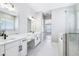 Bright main bathroom featuring dual vanity, marble floors, glass shower, and soaking tub at 5308 Citrus Leaf Blvd, Winter Garden, FL 34787