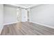 Spacious main bedroom with modern gray vinyl flooring and access to ensuite bath and closets at 5308 Citrus Leaf Blvd, Winter Garden, FL 34787
