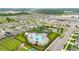 This aerial shot showcases the community pool, clubhouse, playground and parking area, all surrounded by lush landscaping at 622 Taft Dr, Davenport, FL 33837