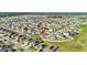 This aerial view features a home surrounded by green lawns in a planned community with neat landscaping at 622 Taft Dr, Davenport, FL 33837