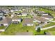 This aerial view showcases houses with enclosed patios and lush green lawns in a well-planned neighborhood at 622 Taft Dr, Davenport, FL 33837