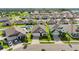 This aerial view highlights well-maintained homes, green lawns and driveways on a quiet street at 622 Taft Dr, Davenport, FL 33837