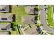 Aerial view of rooftops in a residential neighborhood with green lawns, driveways and a community area with a splash pool at 622 Taft Dr, Davenport, FL 33837