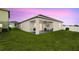 Backyard featuring a covered patio, a well-maintained lawn, and an outdoor seating area at 622 Taft Dr, Davenport, FL 33837