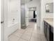 Bathroom with granite countertops, glass shower, bathtub, tile flooring and access to bedroom at 622 Taft Dr, Davenport, FL 33837