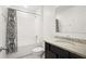 Bathroom with a shower-tub combo, stylish vanity, and a decorative shower curtain at 622 Taft Dr, Davenport, FL 33837