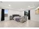 Spacious bedroom with tray ceiling, tile floors, two windows, and baby crib at 622 Taft Dr, Davenport, FL 33837