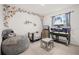 Charming bedroom with floral accents, a play area, and a cozy beanbag chair at 622 Taft Dr, Davenport, FL 33837