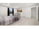 Bright bedroom featuring tile flooring, a modern ceiling fan, and a flatscreen tv at 622 Taft Dr, Davenport, FL 33837