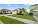 Attractive single-Gathering home with a manicured lawn, complemented by lush greenery and palm trees at 622 Taft Dr, Davenport, FL 33837