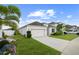 Well-maintained single-Gathering home with a two-car garage, lush lawn, and attractive landscaping at 622 Taft Dr, Davenport, FL 33837