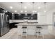 Modern kitchen featuring a breakfast bar, stainless steel appliances, granite counters, and pendant lighting at 622 Taft Dr, Davenport, FL 33837