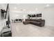 Spacious open-concept living area features a comfortable sectional sofa, dining table, and stylish kitchen at 622 Taft Dr, Davenport, FL 33837