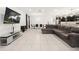 Open-concept living space with a large sectional sofa, dining table, and modern decor at 622 Taft Dr, Davenport, FL 33837