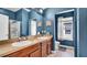 Bathroom featuring a double vanity, neutral tiling, and a walk-in shower at 6462 S Goldenrod Rd # 31B, Orlando, FL 32822