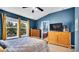 Light-filled bedroom with natural light, warm wood furniture, and an ensuite bathroom at 6462 S Goldenrod Rd # 31B, Orlando, FL 32822