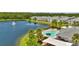 Aerial view of community pool and townhomes along the lake at 6462 S Goldenrod Rd # 31B, Orlando, FL 32822