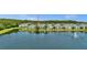 Exterior view of a lakeside home and community with lush landscaping at 6462 S Goldenrod Rd # 31B, Orlando, FL 32822