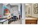 Hallway featuring an office and bathroom, artwork, natural light, and neutral color scheme at 6462 S Goldenrod Rd # 31B, Orlando, FL 32822