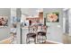 Cozy kitchen nook with bar stools, stainless steel appliances, and adjacent dining area at 6462 S Goldenrod Rd # 31B, Orlando, FL 32822