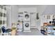 Functional laundry room featuring stacked washer and dryer, shelving, and utility sink for efficient household tasks at 6462 S Goldenrod Rd # 31B, Orlando, FL 32822