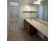 Bright bathroom features a vanity with sink, large mirror, and walk-in shower at 6610 Pampus Dr, Orlando, FL 32819