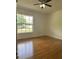 Bedroom with wood floors and a large window providing ample natural light at 6610 Pampus Dr, Orlando, FL 32819