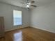 Bedroom with a ceiling fan, window, and wood floors at 6610 Pampus Dr, Orlando, FL 32819