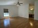 Spacious bedroom with a ceiling fan, window, wood floors, and bathroom vanity at 6610 Pampus Dr, Orlando, FL 32819