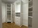 Large walk-in closet with custom shelving and wood floor at 6610 Pampus Dr, Orlando, FL 32819