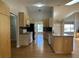 Open kitchen features wood cabinets, granite counters, stainless steel appliances and flows into the living area at 6610 Pampus Dr, Orlando, FL 32819