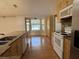 Kitchen with wood floors, wood cabinets, granite countertops, stainless steel appliances, and breakfast nook at 6610 Pampus Dr, Orlando, FL 32819
