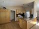 Bright kitchen with light wood cabinets, granite counters, island, and stainless steel appliances at 6610 Pampus Dr, Orlando, FL 32819