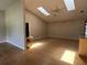 Bright living room with hardwood floors, vaulted ceiling, skylights, and a ceiling fan for comfortable relaxation at 6610 Pampus Dr, Orlando, FL 32819