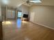 Open living room features hardwood floors, vaulted ceiling with skylights, seamlessly connecting to kitchen and dining areas at 6610 Pampus Dr, Orlando, FL 32819