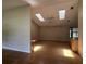Spacious living room with vaulted ceilings, skylights, and hardwood floors for comfortable living at 6610 Pampus Dr, Orlando, FL 32819