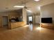 Expansive living room with hardwood floors, vaulted ceiling, skylights, open to the kitchen and dining areas for easy flow at 6610 Pampus Dr, Orlando, FL 32819