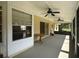 Covered and screened in patio, featuring multiple ceiling fans and an outdoor wooden table at 6610 Pampus Dr, Orlando, FL 32819
