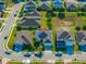 Aerial view showcases a home with solar panels, a pool enclosure, and lush landscaping in a peaceful neighborhood at 826 Sheen Cir Cir, Haines City, FL 33844