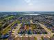 An aerial shot of a residential neighborhood with a marker placed on a charming home surrounded by greenery at 826 Sheen Cir Cir, Haines City, FL 33844