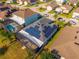 Aerial view of a residence featuring solar panels, a screened pool, and beautifully landscaped yard at 826 Sheen Cir Cir, Haines City, FL 33844