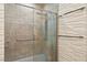 Modern shower with etched-glass doors, a rainfall showerhead, tiled walls and grab bar for accessibility at 826 Sheen Cir Cir, Haines City, FL 33844